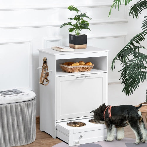 White pet station with a dog, food bowls, and a plant in a room.