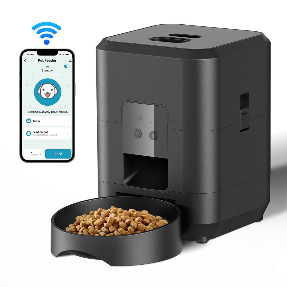 Black pet feeder with a bowl of kibble and smartphone app on a white background